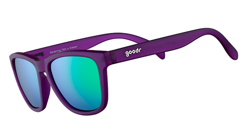 Three-quarter angle view of square-shaped sunglasses with purple frames and reflective green polarised lenses.