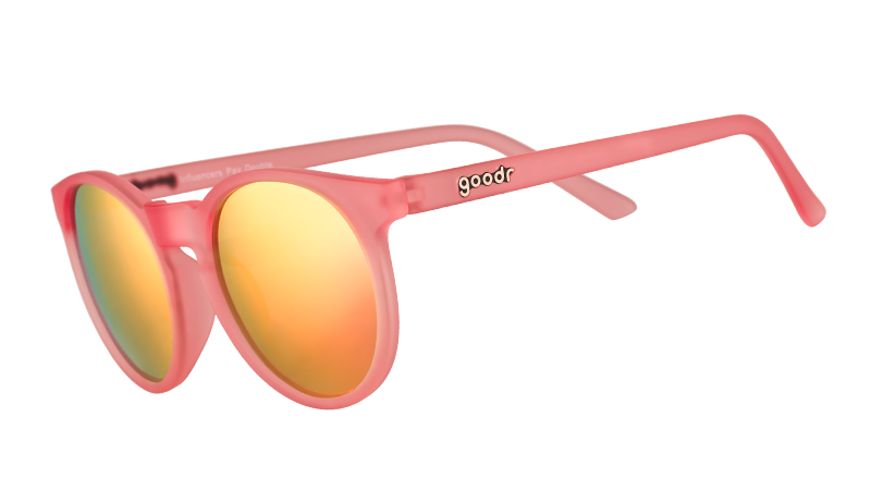 Three-quarter angle view of pink round sunglasses with pink mirrored polarised lenses.