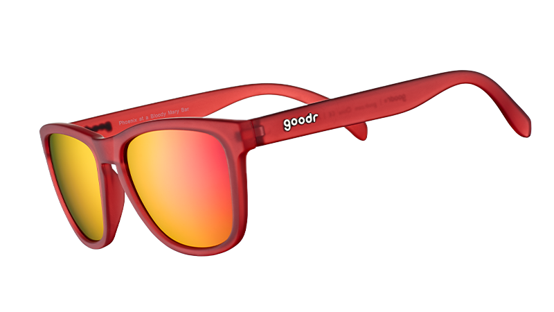 Three-quarter angle view of square-shaped sunglasses with red translucent frames and red reflective lenses.