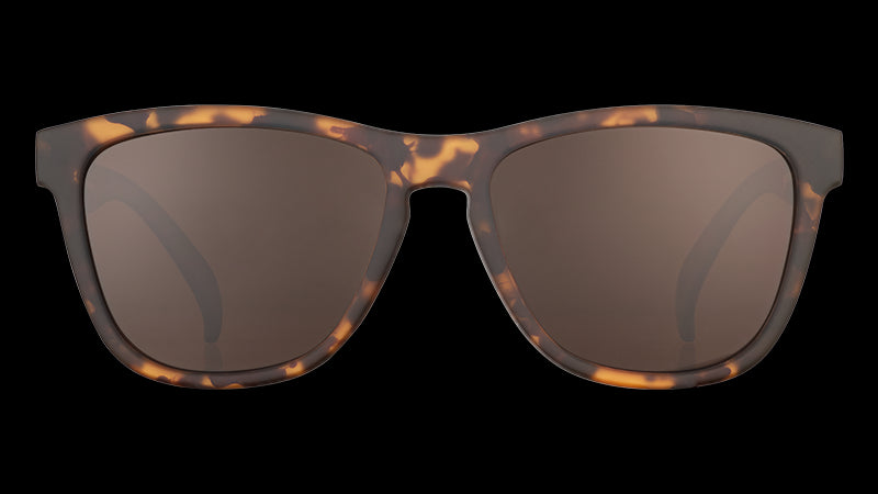 Front view of square-framed brown tortoiseshell sunglasses with brown non-reflective lenses on a white background.