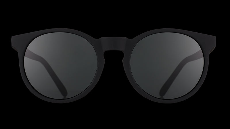 Front view of black round sunglasses with non-reflective black lenses.